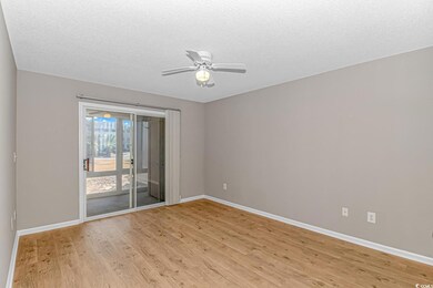 Unfurnished room with a textured ceiling, light ha