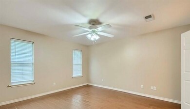 Empty room with ceiling fan and hardwood / wood-style floors
