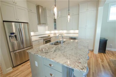 This granite is gorgeous! Definitely not a standard granite. Drawers on side of the island are super functional and other side has a trash pullout. Bosch Dishwasher, Samsung Refrigerator stays and check out this super cool hood! 