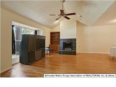 Living area with wood burning fireplace.