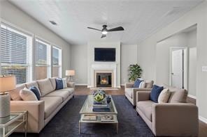 Living room featuring a ceiling fan, baseboards, a
