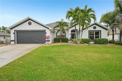 Single story home featuring an attached garage, stucco siding, a front yard, and driveway