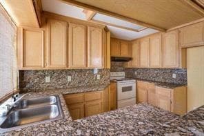 Kitchen with light brown cabinetry, white range with electric cooktop, a sink, under cabinet range hood, and decorative backsplash