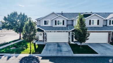Traditional home with driveway, stucco siding, roof with shingles, and stone siding