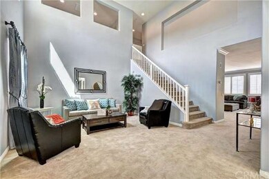 Wide straight staircase leads to upstairs loft are