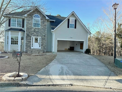 Traditional-style house featuring stone siding, dr