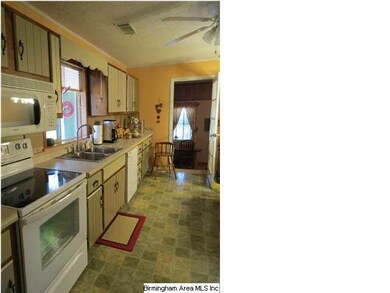 The kitchen offer like new white appliances, tile 