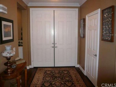 Double door entry with crown moldings and wood flo