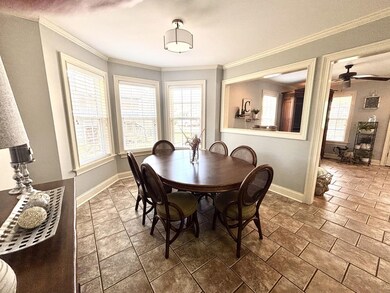 Dining room featuring baseboards, crown molding, a