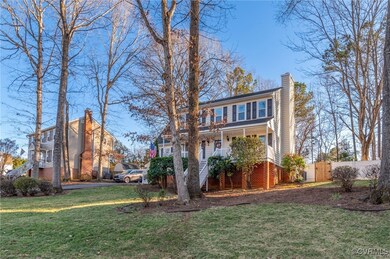 View of front of property with a chimney, a porch,