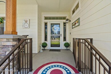 covered front porch with iron railing