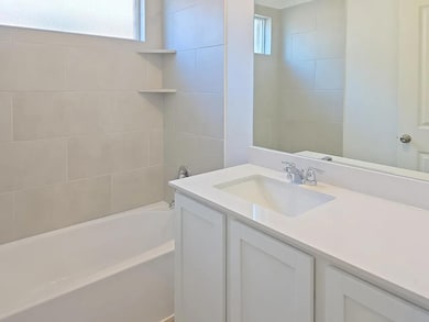 Full bathroom featuring plenty of natural light, vanity, and bathing tub / shower combination