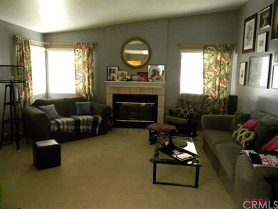 The formal living room has a wood-burning fireplac