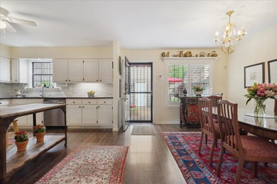 Kitchen with white cabinetry, tasteful backsplash,