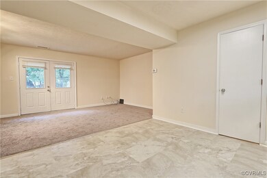 Carpeted empty room featuring a textured ceiling
