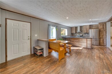 Kitchen featuring stainless steel refrigerator, ta