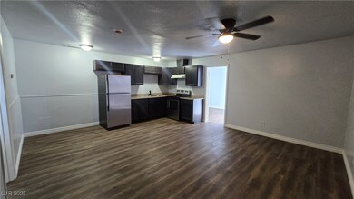 Kitchen with stainless steel appliances, dark wood