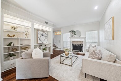 Living room with wall of custom built-ins and fire