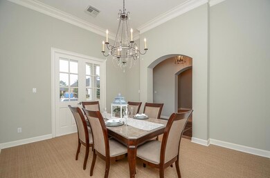 FORMAL dining with chandelier, crown molding, fixed double doors.