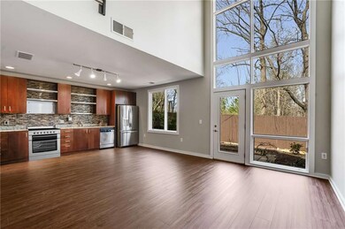 Soaring Ceilings in Family Room with floor to ceiling windows and brand new LVP flooring on main level!