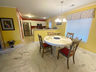 Dining space with crown molding and an inviting ch