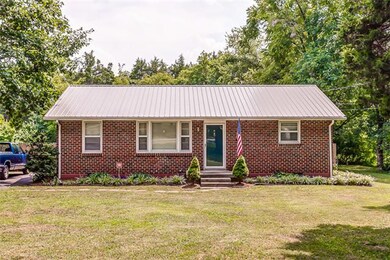 Take a look at this brand new metal roof and the mature landscaping this charming home. 