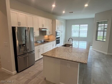 Kitchen with stainless steel appliances, a sink, u