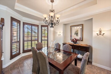 Formal Dining room with tray ceiling, wall sconces