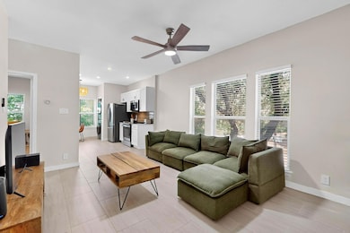 Living room with a ceiling fan and recessed light