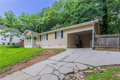 View of front of home with driveway, crawl space, and a porch