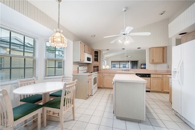 Kitchen with a kitchen island, white appliances, l