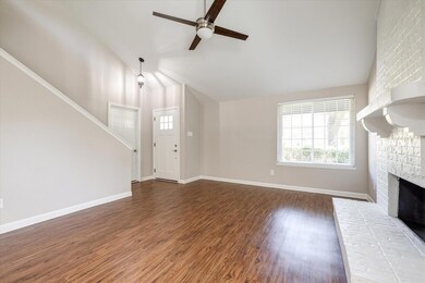 Another view of the front entry ito the home. Once you step inside the front door, you are welcomed by the painted brick fireplace and this light, bright entertaining space.