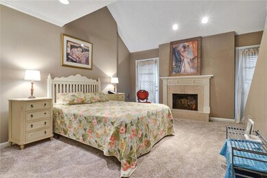 Lovely master bedroom with fireplace and stair to