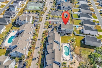 Aerial view of property and surrounding area with nearby suburban area