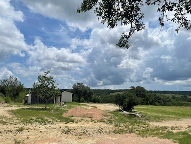 View of yard with an outbuilding and a rural view