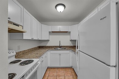 Kitchen offers white cabinets, granite counters an