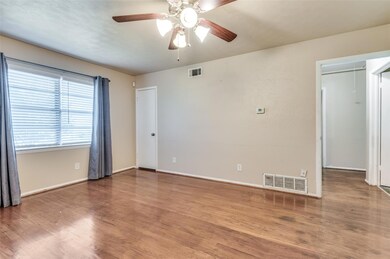 Spare room featuring wood-type flooring and ceilin