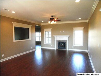 Family room has 10 foot ceilings, wood floooring, ceiling fan, recessed lights, gas fireplace.