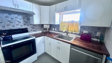 Kitchen with stainless steel dishwasher, under cab