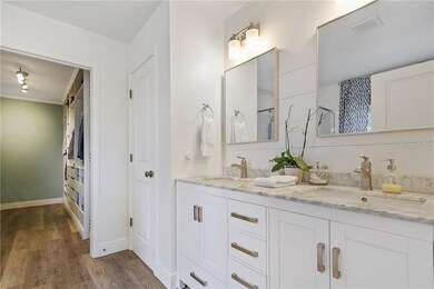 Updated Master Bathroom with Laminate wood plank f