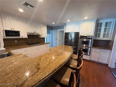 Kitchen with under cabinet range hood, black appli