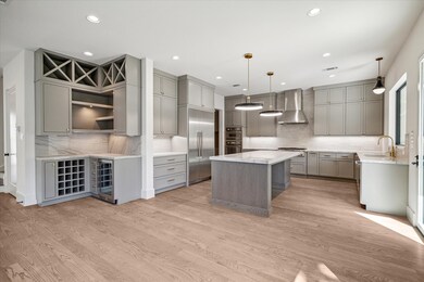 Kitchen and wine bar area with wine refrigerator.