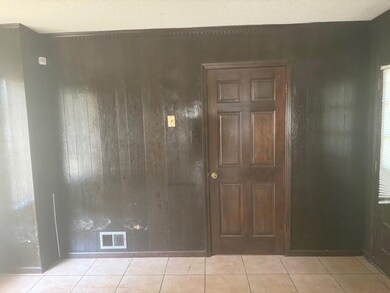 Empty room with light tile patterned flooring