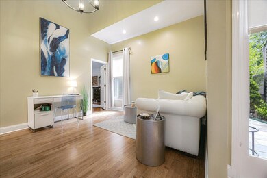 Living area featuring wood finished floors, a chandelier, and recessed lighting