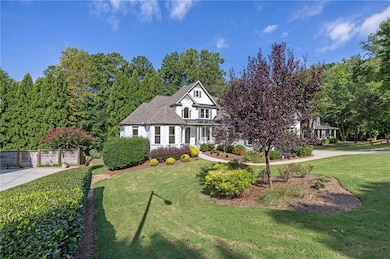 View of front of property with a standing seam roof, a front lawn, a porch, and a metal roof