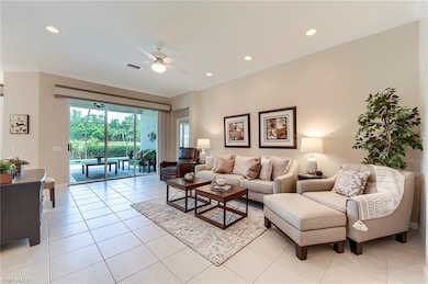 Living room featuring ceiling fan, ornamental molding, light tile patterned flooring, recessed lighting, and baseboards