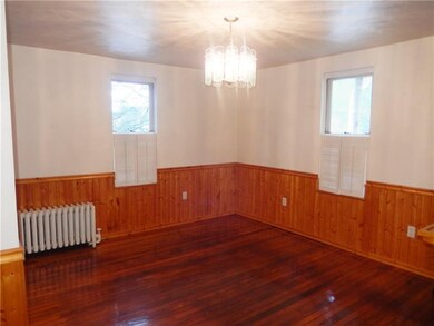 Eat in kitchen with shiny hardwood floors.