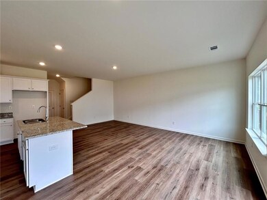 Kitchen with a sink, dark wood finished floors, wh