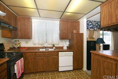Kitchen which is open to the dining room and den.