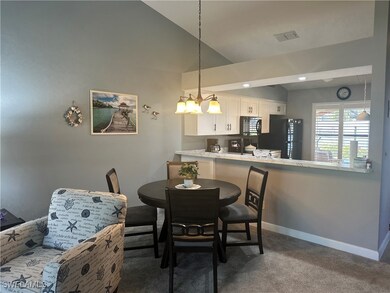 Dining area with a chandelier, vaulted ceiling, an